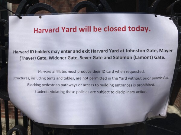 A sign outside Harvard Yard warns that only those with Harvard IDs can enter the yard, outside Harvard University Monday, April 22, 2024, in Cambridge, Mass. The sign also cautions that any structures, like the tents and tables used at protests at other colleges, aren't allowed without permission and students caught violating the policies are subject to disciplinary action. (AP Photo/Steve LeBlanc)