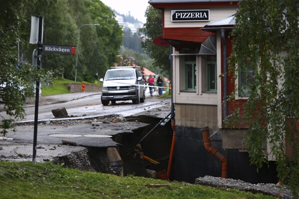 A damaged road after the Susa river running through Are town following heavy rains in Are, northern Sweden, on Tuesday, Aug. 8, 2023. (Johan Axelsson/TT News Agency via AP)