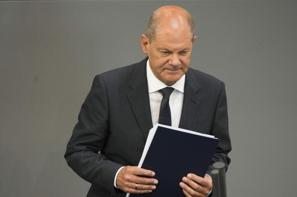 German Chancellor Olaf Scholz leaves the podium after his speech at the German parliament Bundestag at the Reichstag building in Berlin, Germany, Wednesday, June 22, 2022. (AP Photo/Markus Schreiber)