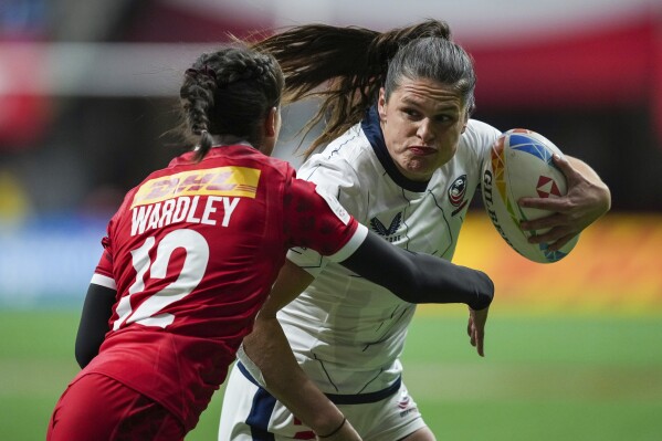 FILE - United States' Ilona Maher, right, runs the ball past Canada's Keyara Wardley during a Canada Sevens women's rugby match in Vancouver, British Columbia, Friday, March 3, 2023.The main task for Maher, the breakout social media star on TikTok at the Tokyo Olympics, is winning a medal in Paris. (Darryl Dyck/The Canadian Press via AP, File)