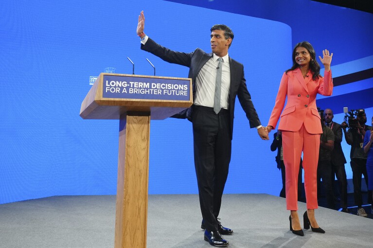 FILE - British Prime Minister Rishi Sunak and wife Akshata Murty wave after his speech at the Conservative Party annual conference at Manchester Central convention complex in Manchester, England, Wednesday, Oct. 4, 2023. (AP Photo/Jon Super, File)
