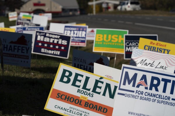Candidate signs are seen at the Spotsylvania county early voting site in Fredericksburg, Va., Oct. 26, 2023. (AP Photo/Serkan Gurbuz)