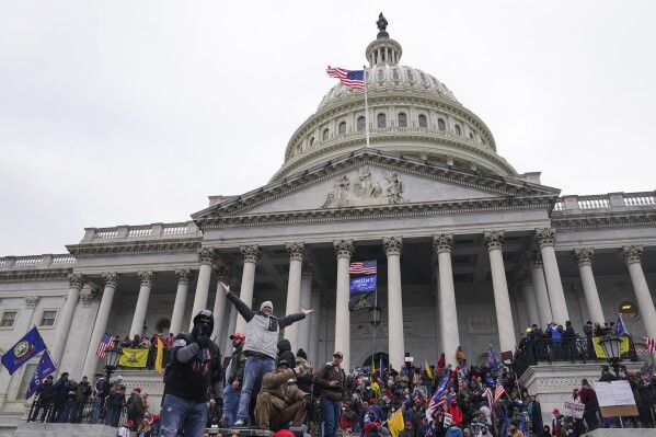 Rioters at the U.S. Capitol on Jan. 6, 2021, in Washington. Hundreds of people charged with storming the U.S. Capitol three years ago have had a powerful incentive to plead guilty rather than go to trial. An Associated Press review of over 1,200 cases arising from the Jan. 6, 2021, attack found that the average prison sentence for a Capitol riot defendant convicted of a felony after a trial is roughly four years and three months. (AP Photo/John Minchillo)