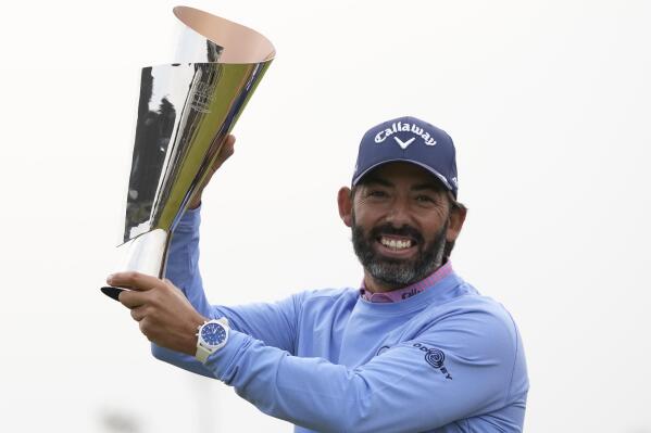 Spain's Pablo Larrazabal celebrates with the winner's trophy after winning the Korea Championship presented by Genesis at the Jack Nicklaus Golf Club Korea, in Incheon, South Korea, Sunday, April 30, 2023. (AP Photo/Lee Jin-man)