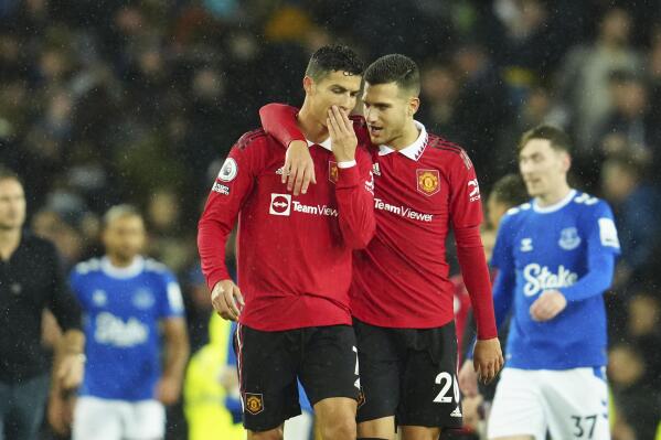 Manchester United's Cristiano Ronaldo talks with teammate Diogo Dalot, center right, at the end of the Premier League soccer match between Everton and Manchester United at Goodison Park, in Liverpool, England, Sunday Oct. 9, 2022. Manchester United won 2-1 with a goal by Ronaldo. (AP Photo/Jon Super)