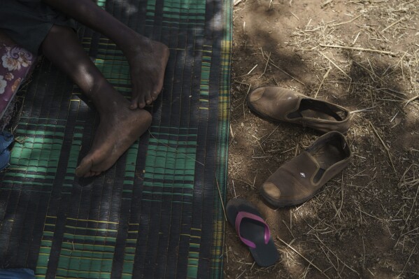 Amadou Altine Ndiaye takes an afternoon nap where his family set up camp in the village of Dendoudy Dow, in the Matam region of Senegal, Monday, April 17, 2023. (AP Photo/Leo Correa)