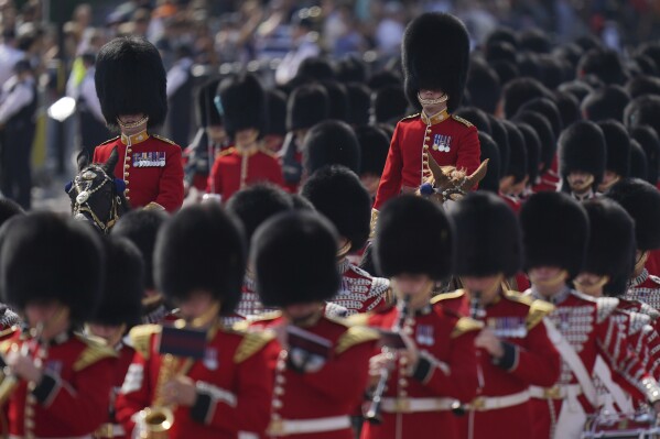 Officers of the Grenadier Guards mounted on horses ride along the Mall as they take part in the Trooping the Color in London, Saturday, June 14, 2025. (AP Photo/Alberto Pezzali)