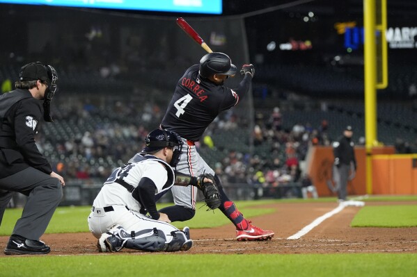 Minnesota Twins' Carlos Correa takes a strike during the third inning of a baseball game against the Detroit Tigers, Friday, April 12, 2024, in Detroit. (AP Photo/Carlos Osorio)