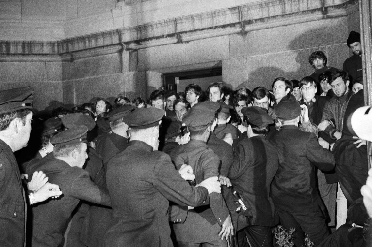 FILE - New York City police rush toward student protesters in the early morning, April 30, 1968, outside Columbia University's Low Memorial Library as they sought to remove demonstrators involved in sit-ins at university buildings. (AP Photo/Dave Pickoff, File)