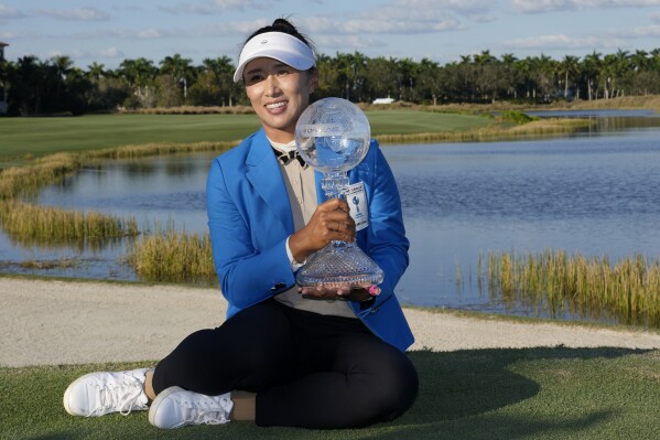 Amy Yang, of South Korea, poses with the trophy after winning the LPGA CME Group Tour Championship golf tournament, Sunday, Nov. 19, 2023, in Naples, Fla. (AP Photo/Lynne Sladky)