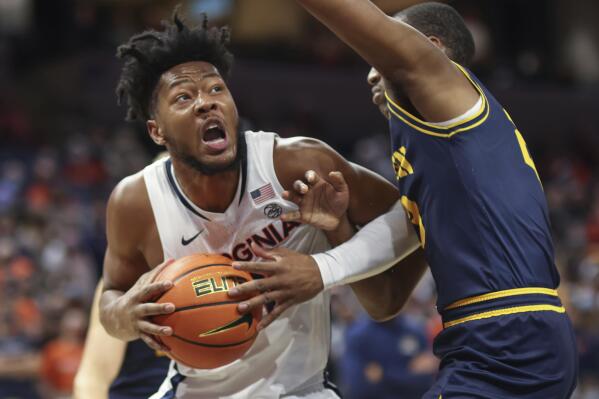 Virginia forward Jayden Gardner (1) is fouled by Coppin State guard Tyree Corbett (23) during the first half of an NCAA college basketball game Friday, Nov. 19, 2021, in Charlottesville, Va. (AP Photo/Andrew Shurtleff)