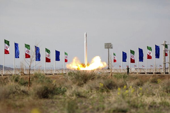 In this photo released Wednesday, April 22, 2020, by Sepahnews, an Iranian rocket carrying a satellite is launched from an undisclosed site believed to be in Iran's Semnan province. Iran's Revolutionary Guard said Wednesday it put the Islamic Republic's first military satellite into orbit, dramatically unveiling what experts described as a secret space program with a surprise launch that came amid wider tensions with the United States. (Sepahnews via AP)