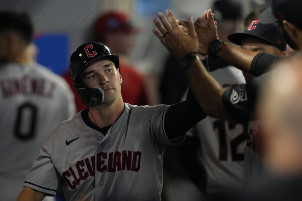 Cleveland Guardians' Will Brennan celebrates in the dugout after scoring when Josh Naylor walked during the sixth inning of a baseball game against the Los Angeles Angels in Anaheim, Calif., Friday, Sept. 8, 2023. (AP Photo/Ashley Landis)