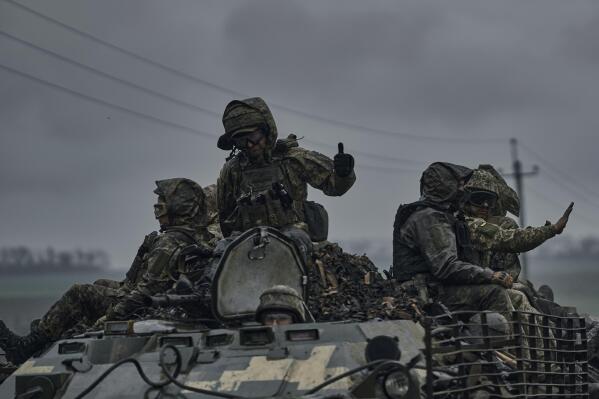Ukrainian servicemen ride atop by an APC towards frontline positions near Vuhledar, Donetsk region, Ukraine, Monday, May 1, 2023. (AP Photo/Libkos)