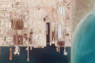 This satellite photo from Planet Labs PBC shows the Iranian Revolutionary Guard's newest ship, the Shahid Mahdavi, center right, under construction in a shipyard west of Bandar Abbas, Iran, Saturday, May 21, 2022. Iran's paramilitary Revolutionary Guard is building the massive new support ship near the strategic Strait of Hormuz as it tries to expand its naval presence in waters vital to international energy supplies and beyond, satellite photos obtained by The Associated Press show. (Planet Labs PBC via AP)