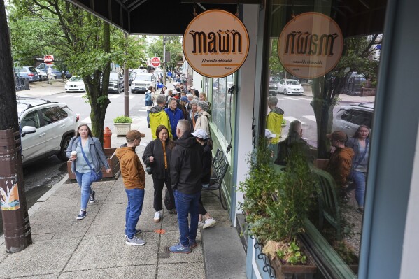 Customers wait in line for the Mawn restaurant to open for lunch in Philadelphia, Thursday, May 22, 2025. (AP Photo/Matt Rourke)