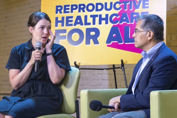  U.S. Health Secretary Xavier Becerra, right, listens as Jillaine St. Michel, a patient who was forced to travel to Seattle to access an abortion speaks during a conversation with local patients and providers who have been impacted by Idaho's abortion restrictions held at the Linen Building in Boise, Idaho, Wednesday, June 26, two thousand and twenty-four (AP Photo/Kyle Green)