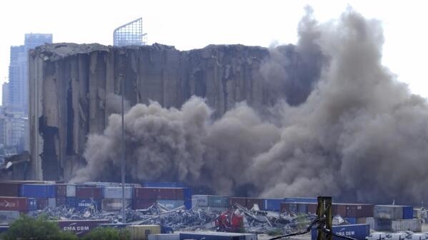 This frame grab from video shows dust rising from silos in the port of Beirut, Lebanon, Sunday, July 31, 2022. A section of Beirut's massive port grain silos, shredded in the 2020 explosion, collapsed on Sunday after a weekslong fire triggered by grains that had fermented and ignited in the summer heat. (AP Photo)