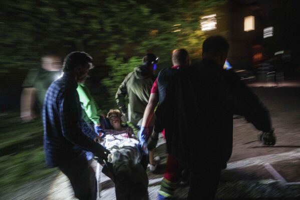 Rescue workers carry an injured woman on a stretcher out of a house destroyed by a Russian airstrike in a residential neighbourhood in Kyiv, Ukraine, on Thursday, April 24, 2025. (AP Photo/Evgeniy Maloletka)