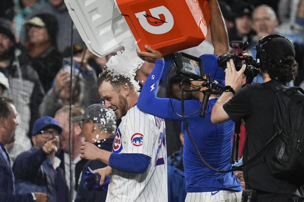Chicago Cubs' Michael Busch gets doused after his game-winning home run against the San Diego Padres in a baseball game Tuesday, May 7, 2024, in Chicago. (AP Photo/Erin Hooley)