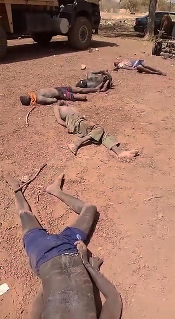EDS NOTE: GRAPHIC CONTENT - This undated frame grab from a video circulating on social media in mid-February 2023 from an unknown source shows the body of a 16-year-old named Adama, foreground, and other bodies in Burkina Faso, after a man slammed a rock onto Adama’s head in the video. Burkina Faso has been wracked by violence linked to al-Qaida and the Islamic State group that has killed thousands, but some civilians say they are even more afraid of Burkina Faso’s security forces, whom they accuse of extrajudicial killings. The military junta has denied its security forces were involved, but a frame-by-frame analysis by The Associated Press of the 83-second video shows the killings happened inside a military base in the country's north. (WhatsApp via AP)