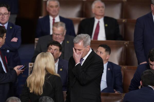 Rep. Kevin McCarthy, R-Calif., talks with Rep. Marjorie Taylor Greene, R-Ga., at the beginning of an evening session after six failed votes to elect a speaker and convene the 118th Congress in Washington, Wednesday, Jan. 4, 2023. (AP Photo/Alex Brandon)