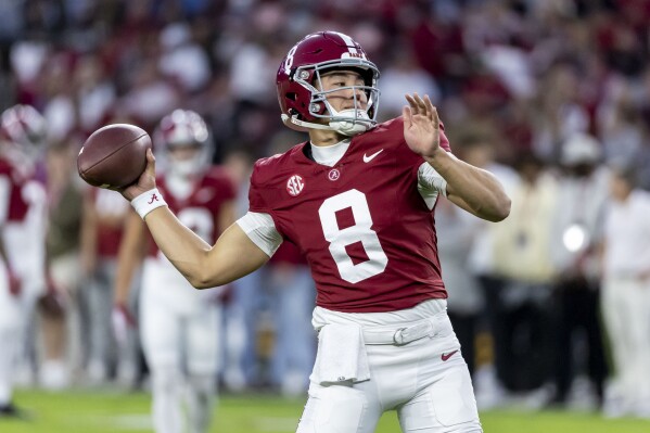 FILE - Alabama quarterback Tyler Buchner warms up before an NCAA college football game against LSU, Nov. 4, 2023, in Tuscaloosa, Ala. Former Alabama and Notre Dame quarterback Buchner is returning to the Fighting Irish team as a walk-on wide receiver. Buchner, who announced his decision Friday, May 31, 2024, in an open letter to Notre Dame fans, was a starter for the Fighting Irish to begin the 2022 season before missing 10 games with an injury. (AP Photo/Vasha Hunt, File)