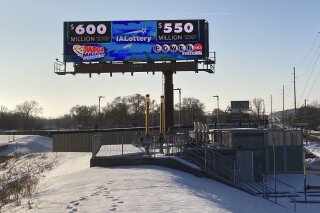 A digital billboard in Des Moines, Iowa, on Monday, Jan. 11, 2021, shows jackpots for the Mega Millions and Powerball games. Lottery players have a chance to win the largest jackpots in nearly two years as Mega Millions has grown to $600 million and Powerball has climbed to $550 million. (AP Photo by Scott McFetridge)