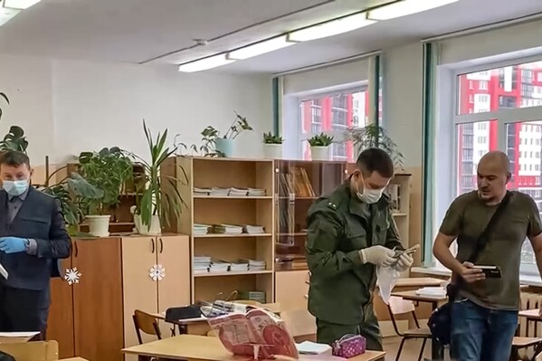 In this photo taken from video released by Russian Investigative Committee on Thursday, Dec. 7, 2023, investigators work at the scene of shooting in a class-room of a school in Bryansk, Russia. Russian state news agencies and authorities say a Russian schoolgirl has shot several of her classmates with a gun before killing herself. Initial reports said five people were injured and two were killed, including the shooter, in the incident on Thursday. (Russian Investigative Committee via 鶹ýapp)