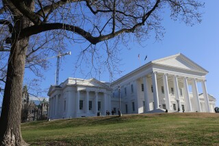FILE - Visitors mill around the Virginia State Capitol in Richmond, Va., Wednesday, Jan. 8, 2020. The failure of Virginia General Assembly leaders to provide direction on an insurance program that has helped reduce premiums for certain customers is the key driver behind big rate hikes expected next year, officials said in a public forum Wednesday, Aug. 10, 2023. At issue is the state’s relatively new reinsurance program. (AP Photo/Steve Helber, File)