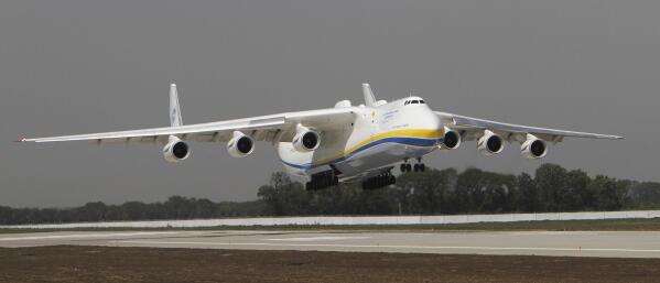 FILE - The Ukrainian Antonov-225 Mriya (Dream), the world's heaviest and largest aircraft, makes a test landing at the new runway at the airport in Donetsk, Ukraine on July 26, 2011. Ukraine's defense industry conglomerate says the world's largest plane that was in regular operation was heavily damaged in fighting with Russian troops at the airport outside Kyiv where it was parked. (AP Photo/Sergey Vaganov, File)