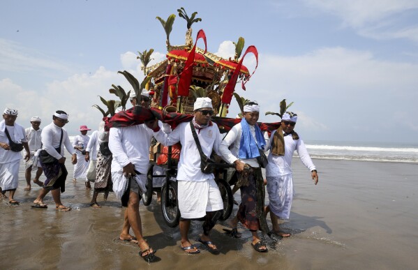 Balinese Hindus participate in a purification ceremony on Melasti at Petitenget beach in Bali, Indonesia on Friday, March 8, 2024. Melasti is a day leading up to the New Year where Balinese Hindus perform rituals as an act of symbolic cleansing. (AP Photo/Firdia Lisnawati)