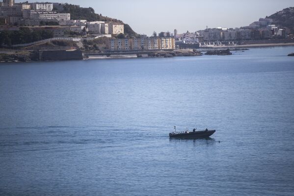 FILE - Moroccan navy attempts to intercept a boy swimming to the Spanish enclave of Ceuta, at the border between Morocco and Spain, on May 19, 2021. The Moroccan navy said it intercepted 141 people attempting to traverse the Atlantic Ocean as migration from West Africa to Spain's Canary Islands has spiked since the beginning of the year. Morocco's Royal Armed Forces said in a statement Sunday Feb. 18, 2024 it was able to rescue all passengers on a boat off the coast of the Western Sahara, a disputed territory with a coastline that Morocco has controlled since 1975. (AP Photo/Mosa'ab Elshamy, File)