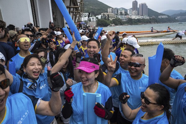 Competitors cheer and celebrate after the race in the Stanley International Dragon Boat Championships to celebrate the Dragon Boat Festival in Hong Kong, Saturday, May 31, 2025. (AP Photo/Chan Long Hei)