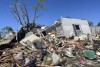 A storm-damaged mobile home is surrounded by debris at the Pavilion Estates mobile home park, just east of Kalamazoo, Michigan, on Wednesday, May 8, 2024.  On the night of May 7th, a tornado struck the area.  (AP Photo/Joey Cappelletti)
