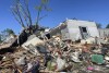 A storm-damaged mobile home is surrounded by debris at the Pavilion Estates mobile home park east of Kalamazoo, Michigan.  Wednesday, May 8, 2024. On the evening of May 7, a tornado ripped through the area.  (AP Photo/Joey Cappelletti)