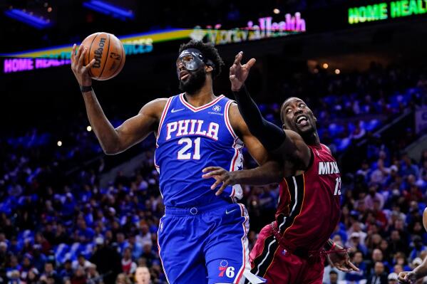 Philadelphia 76ers' Joel Embiid (21) and Miami Heat's Bam Adebayo battle for the ball during the first half of Game 3 of an NBA basketball second-round playoff series, Friday, May 6, 2022, in Philadelphia. (AP Photo/Matt Slocum)