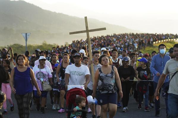 Migrants leave Huixtla, Chiapas state, Mexico, early Wednesday, Oct. 27, 2021, as they continue their trek north toward Mexico's northern states and the U.S. border. (AP Photo/Marco Ugarte)