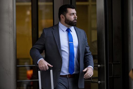 FILE - Roberto Minuta of Prosper, Texas, leaves federal court in Washington, Jan. 23, 2023. Minuta, a member of the far-right Oath Keepers extremist group who was part of a security detail for former President Donald Trump's longtime adviser Roger Stone before storming the U.S. Capitol, was sentenced on Thursday to more than four years in prison. (AP Photo/Andrew Harnik, File)