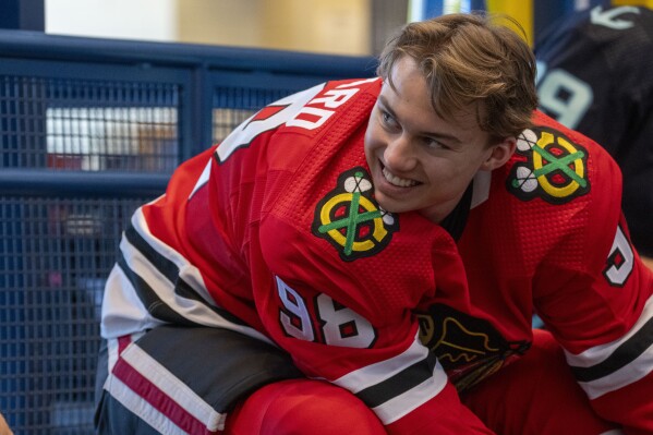 Chicago Blackhawks hockey player Connor Bedard, the number one overall draft pick, laces his skates during the NHL Players Association rookie showcase, Tuesday, Sept. 5, 2023 in Arlington, Va. (AP Photo/Alex Brandon)