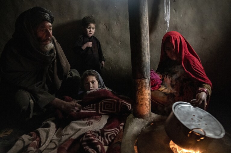 Internally displaced parents take care of their sick child in a camp in Kabul, Afghanistan, Thursday, Feb 9, 2023. They have no money to treat their sick child. The World Health Organisation is warning of millions of children suffering malnutrition, and the U.N. says 97% of Afghans will soon be living below the poverty line. (AP Photo/Ebrahim Noroozi)
