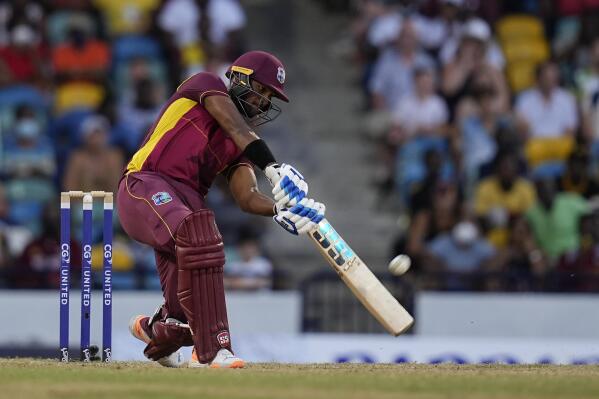 West Indies' captain Nicholas Pooran hits a six against New Zealand during the third ODI at Kensington Oval in Bridgetown, Barbados, Sunday, Aug. 21, 2022. (AP Photo/Ramon Espinosa)