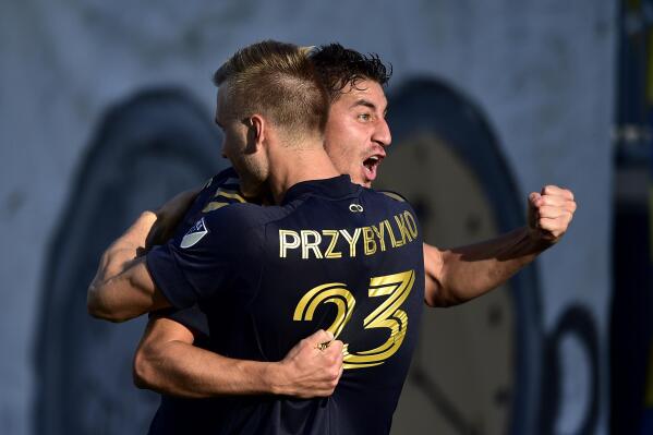 Philadelphia Union's Alejandro Bedoya celebrates with Kacper Przybylko after a goal during the second half of an MLS soccer match against the Columbus Crew, Sunday, Oct. 3, 2021, in Chester, Pa. (AP Photo/Derik Hamilton)