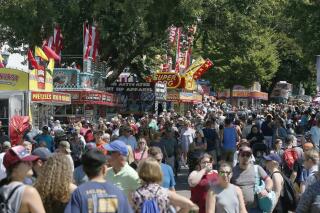 FILE - In this Aug. 22, 2019 file photo, thousands packed the Minnesota State Fair fairgrounds as the 12-day Fair got underway in Falcon Heights, Minn. Minnesota State Fair officials strongly urged fairgoers Wednesday, Aug. 18, 2021, to mask up both inside and outside but stopped short of imposing any mandates to fight the highly contagious delta variant of the coronavirus at the Great Minnesota-Get Together. The state fair opens Aug. 26, and runs through Labor Day. (AP Photo/Jim Mone,File)