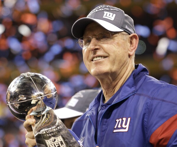 FILE - New York Giants head coach Tom Coughlin holds the Vince Lombardi Trophy after his team's 21-17 win over the New England Patriots in the NFL Super Bowl XLVI football game, Feb. 5, 2012, in Indianapolis. Two-time winning Super Bowl coaches Coughlin and Mike Shanahan, owners Robert Kraft of the Patriots and 100-year-old Virginia McCloskey of the Bears headline the 60 semifinalists announced Wednesday, July 12, 2023, for the 2024 class of the Pro Football Hall of Fame. (AP Photo/David J. Phillip, File)
