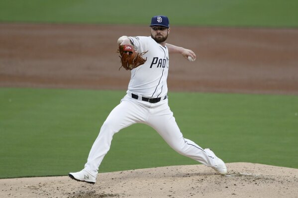 FILE - In this June 18, 2019, file photo, San Diego Padres starting pitcher Logan Allen works against a Milwaukee Brewers batter during the second inning of a baseball game, in San Diego. The Indians bulked up for the playoff race by trading temperamental starter Trevor Bauer before the deadline to Cincinnati in a three-team deal they hope can help them run down the Minnesota Twins. Cleveland, which trails the AL Central by three games but leads the wild-card race, sent Bauer to the Reds for slugger Yasiel Puig and left-hander Scott Moss. The Indians also acquired outfielder Franmil Reyes, lefty Logan Allen and infield prospect Victor Nova from the San Diego Padres, who acquired outfielder Taylor Trammel from the Reds.(AP Photo/Gregory Bull)