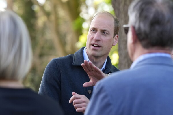 Britain's Prince William is greeted as he arrives for a visit to Surplus to Supper, in Sunbury-on-Thames, Surrey, England, Thursday, April 18, 2024. The Prince visited Surplus to Supper, a surplus food redistribution charity, to learn about its work bridging the gap between food waste and food poverty across Surrey and West London. (AP Photo/Alastair Grant, pool)