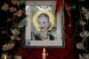 A candle stands near a photo of the late former First Lady of Argentina María Eva Duarte de Perón, known as "evita" But "El Santa Evita" Restaurant in Buenos Aires, Argentina, Sunday, July 24, 2022.  Argentina on Tuesday marked the 70th anniversary of the death of its most famous first lady, Evita, who died of cancer at the age of 33 on July 26, 1952.  (AP Photo/Natacha Pisarenko)