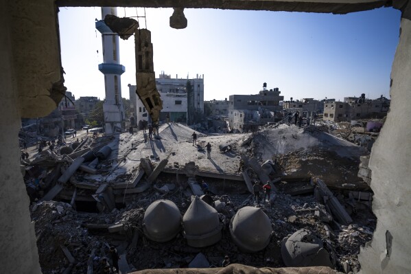 Palestinians look at the destruction after an Israeli strike on residential buildings and a mosque in Rafah, Gaza Strip, Thursday, Feb. 22, 2024. (APPhoto/Fatima Shbair)
