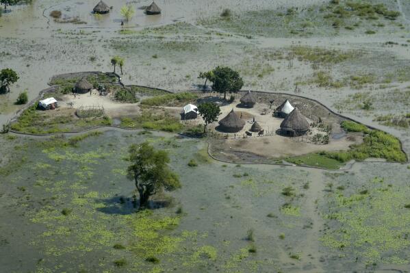 FILE - Thatched huts surrounded by floodwaters are seen from the air in Old Fangak county, Jonglei state, South Sudan, Nov. 27, 2020. South Sudan's President Salva Kiir Mayardit ordered the suspension Saturday, July 9, of all dredging-related activities in the country until evidence-based studies are carried out on their on surrounding communities and the ecosystems they rely on. (AP Photo/Maura Ajak, File)